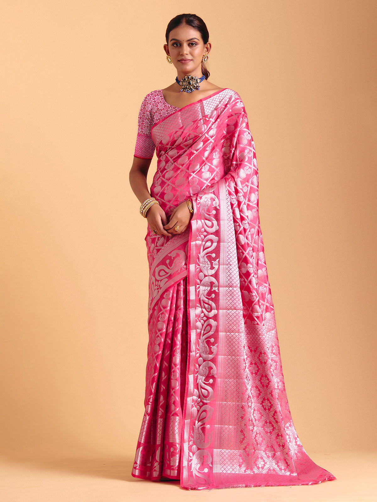 Pink silk saree enhanced with elegant zari detailing