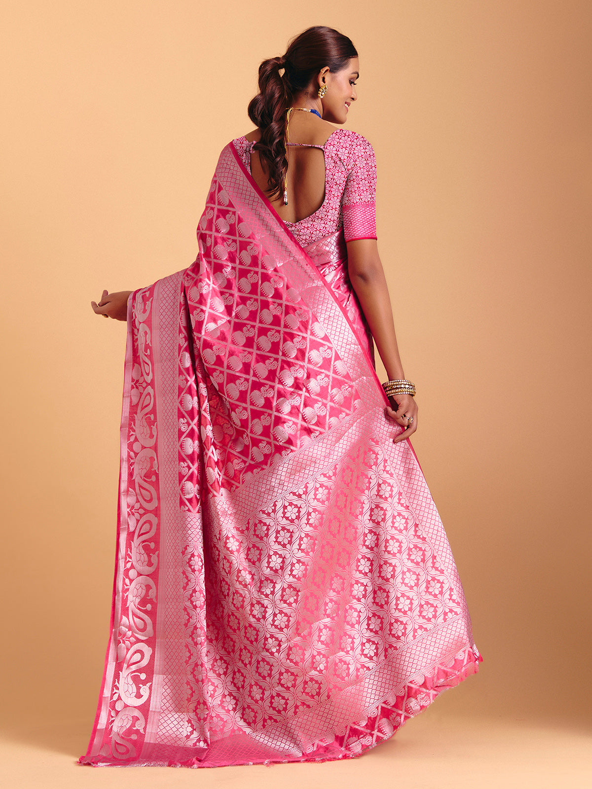 Pink silk saree enhanced with elegant zari detailing