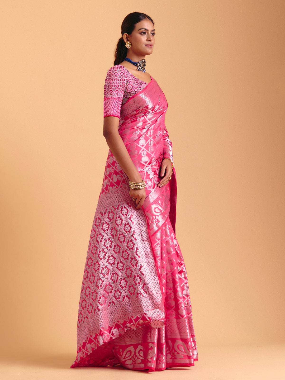 Pink silk saree enhanced with elegant zari detailing