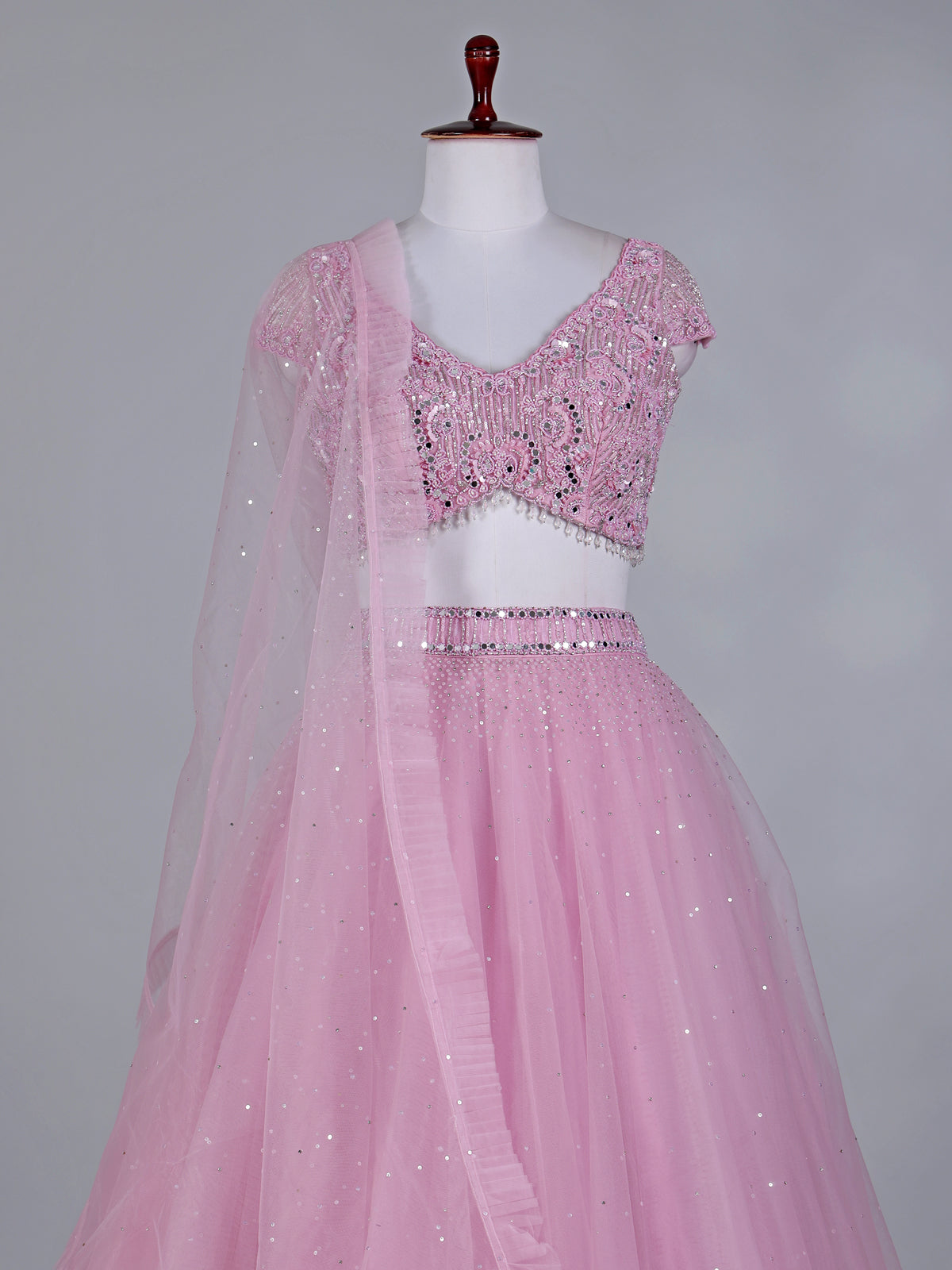 Light pink net lehenga choli with mirror and stone work