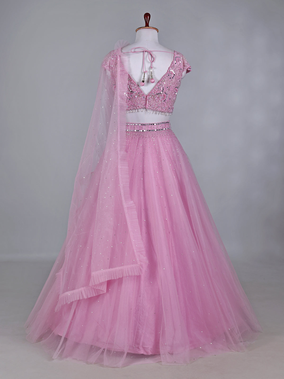 Light pink net lehenga choli with mirror and stone work