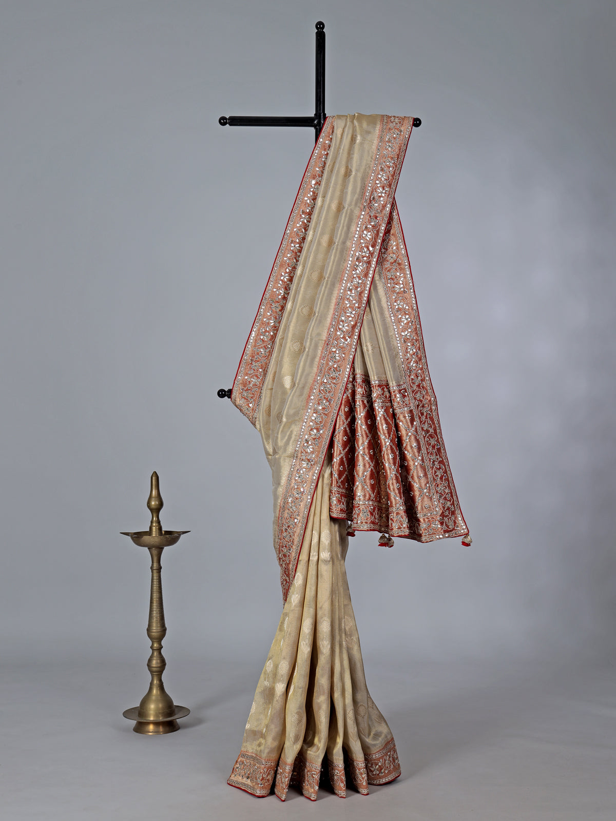 Cream shimmer tissue silk saree with festive border