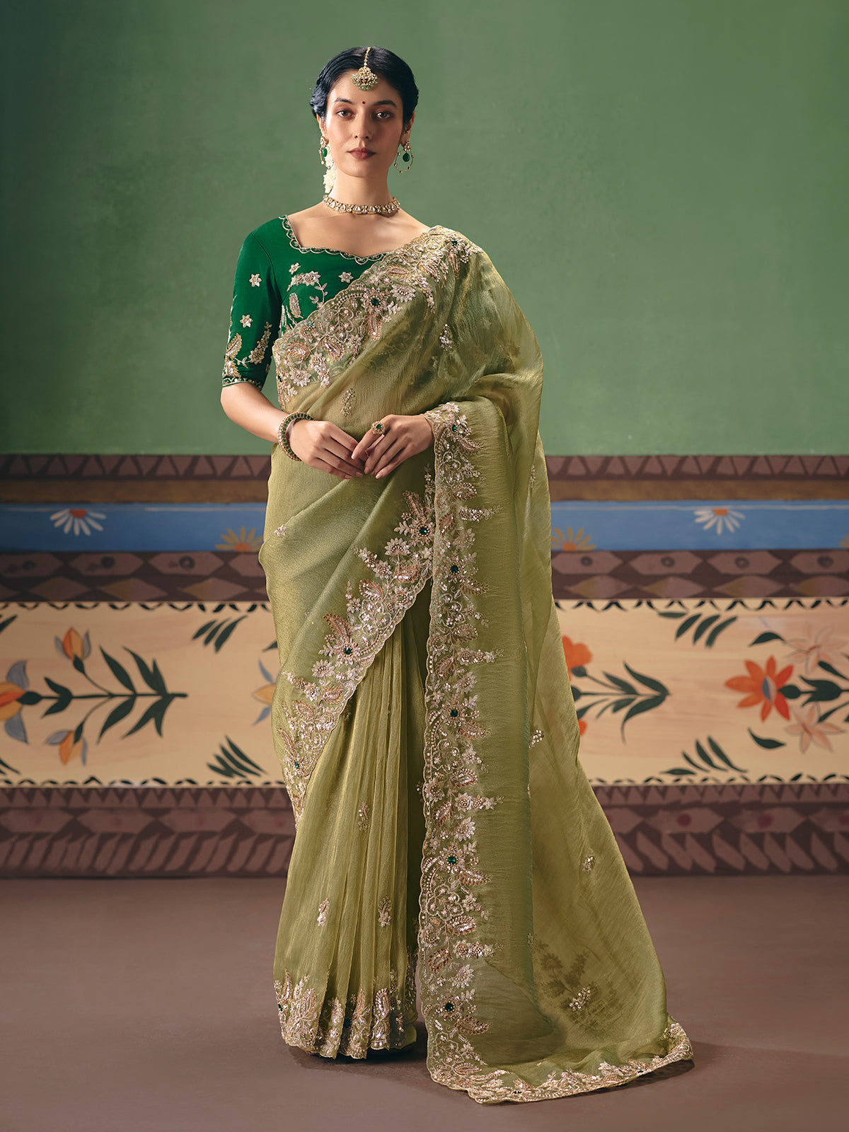 Olive green fancy silk saree accented with resham work