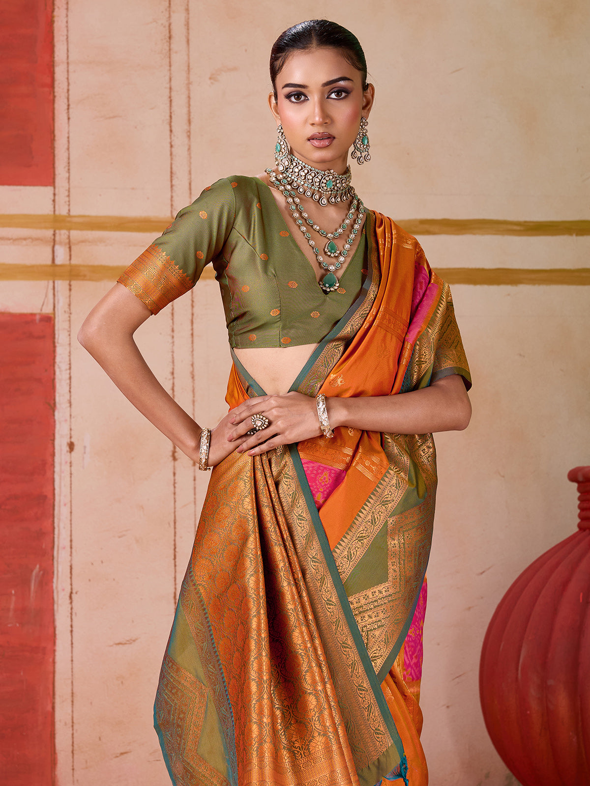 Orange silk saree with bold green border