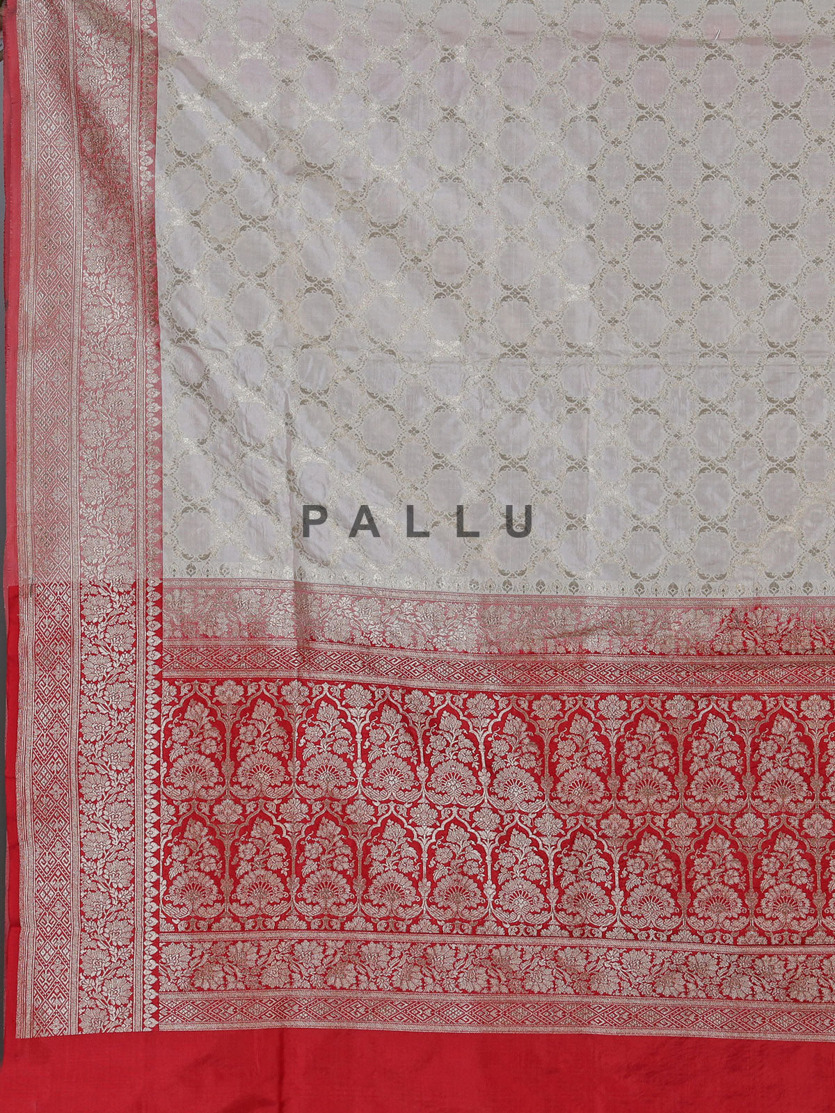 Off white banarasi silk saree with delicate zari detailing