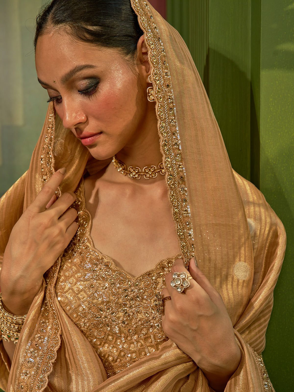 Golden silk lehenga choli with woven motifs and tissue dupatta