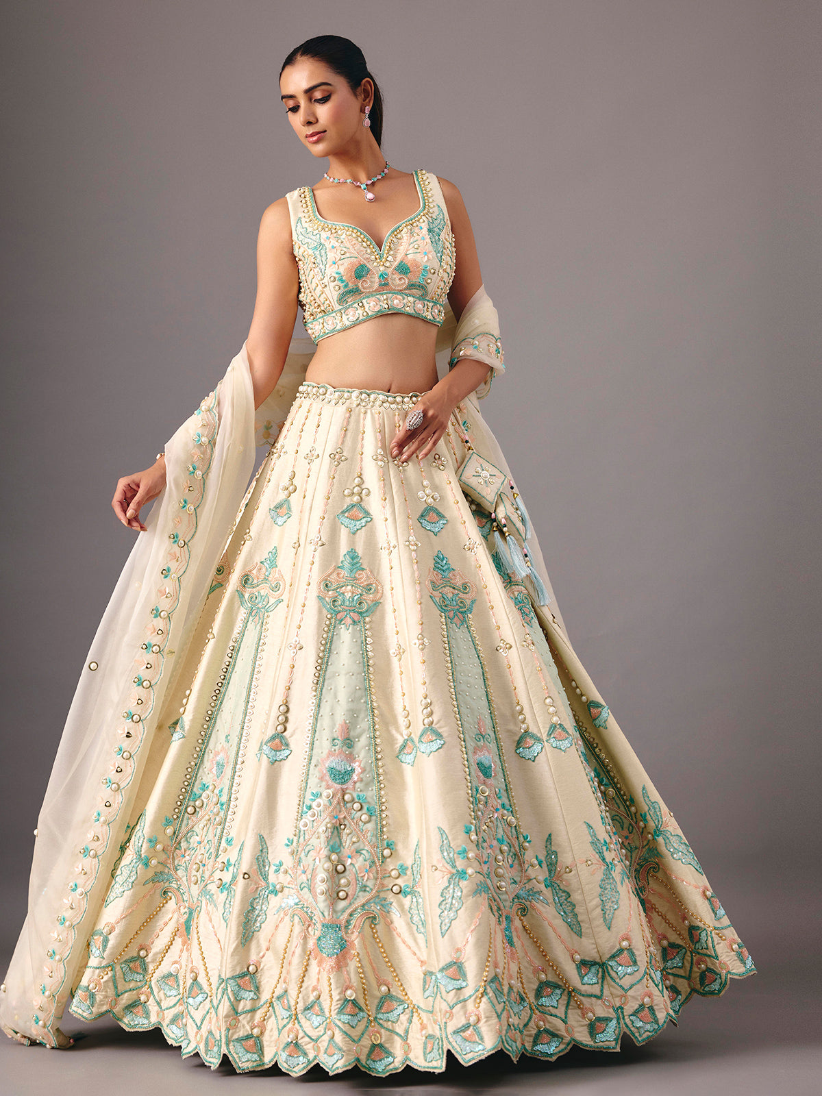 Cream silk lehenga choli with pearl and thread detailing