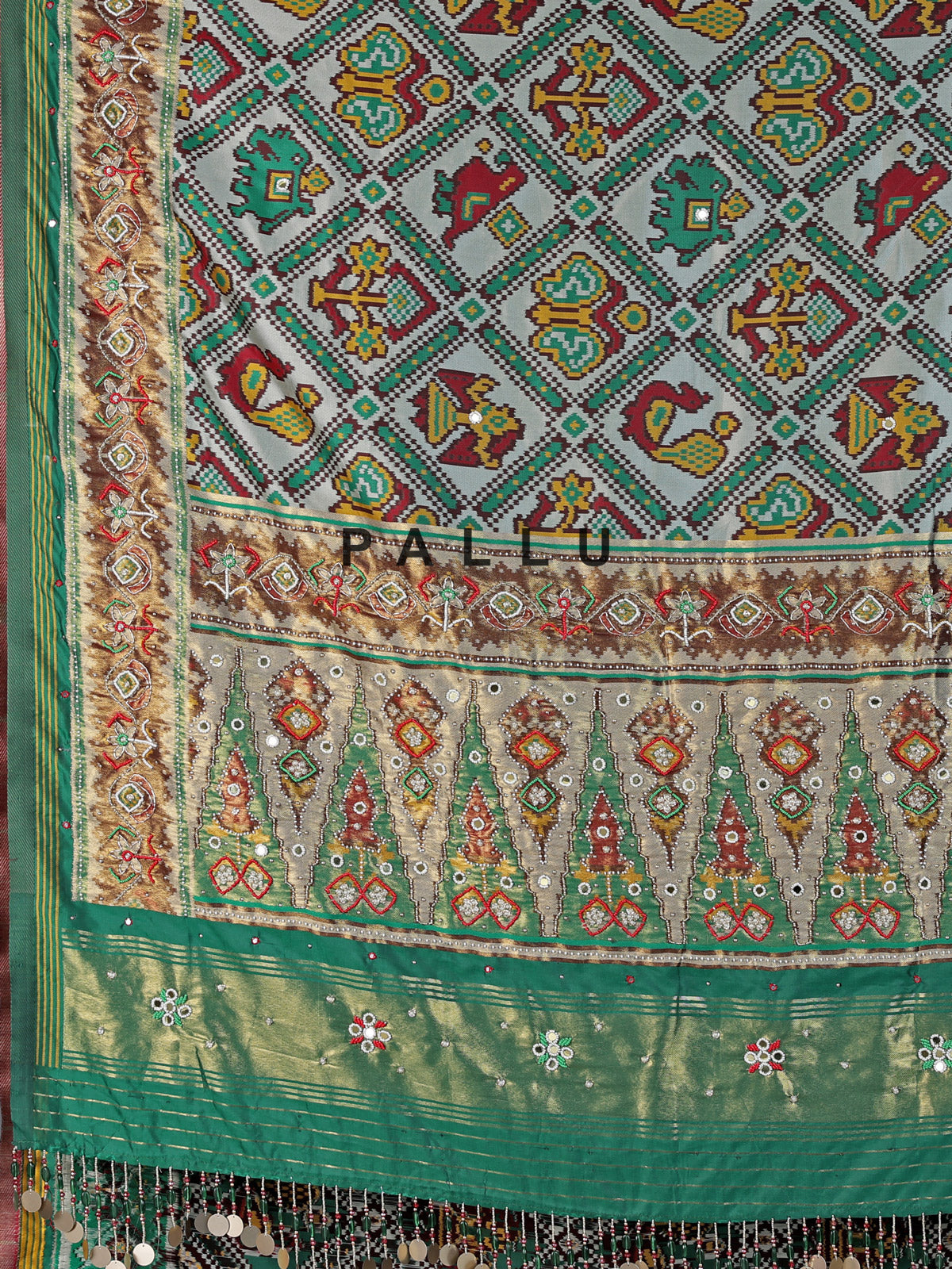 Green and white patola silk saree with rich embellishments