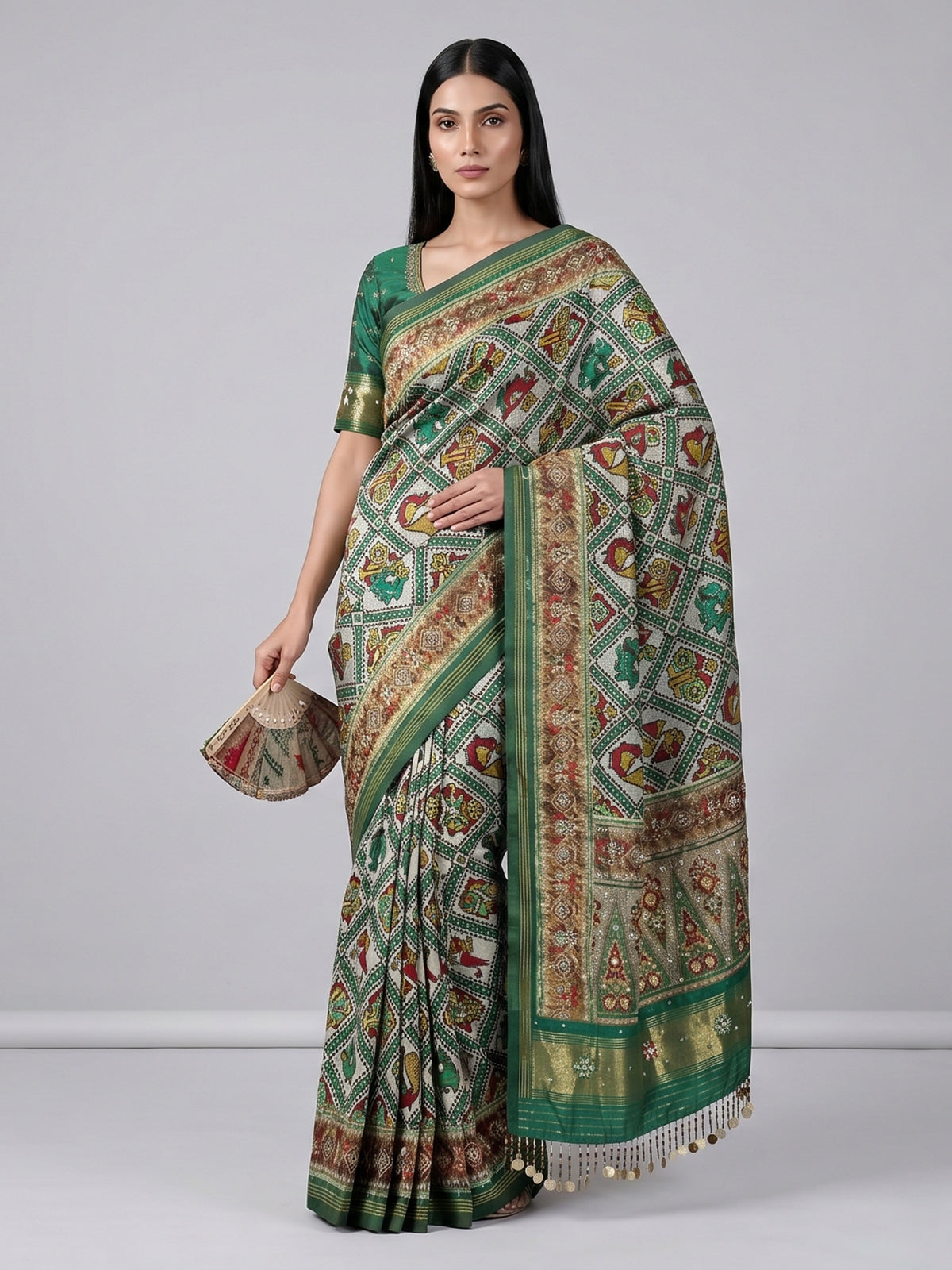 Green and white patola silk saree with rich embellishments