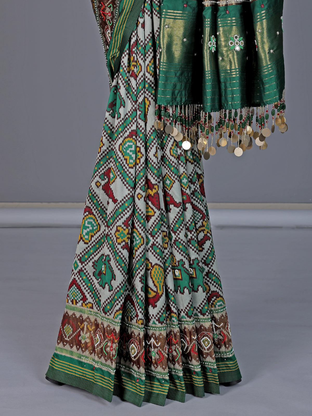 Green and white patola silk saree with rich embellishments