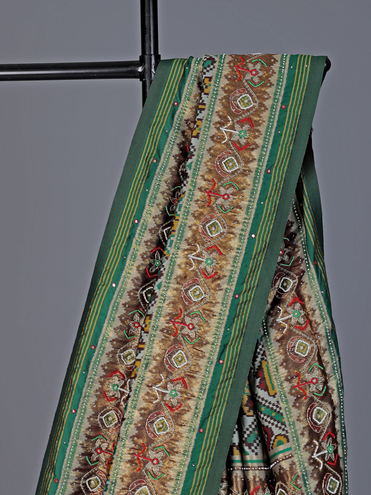 Green and white patola silk saree with rich embellishments