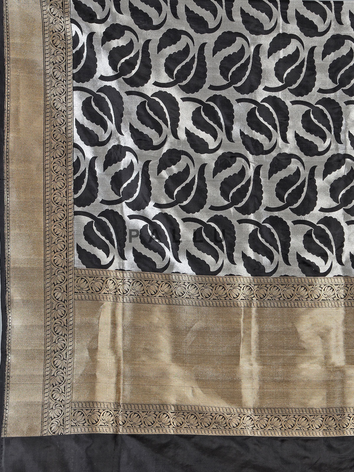 Black banarasi silk saree adorned with elegant silver zari detailing