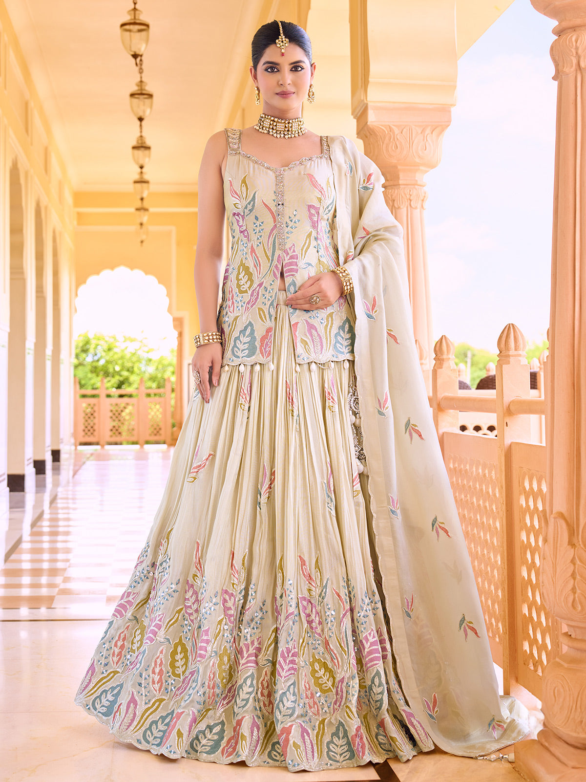Cream silk lehenga choli with colorful motif embellishments
