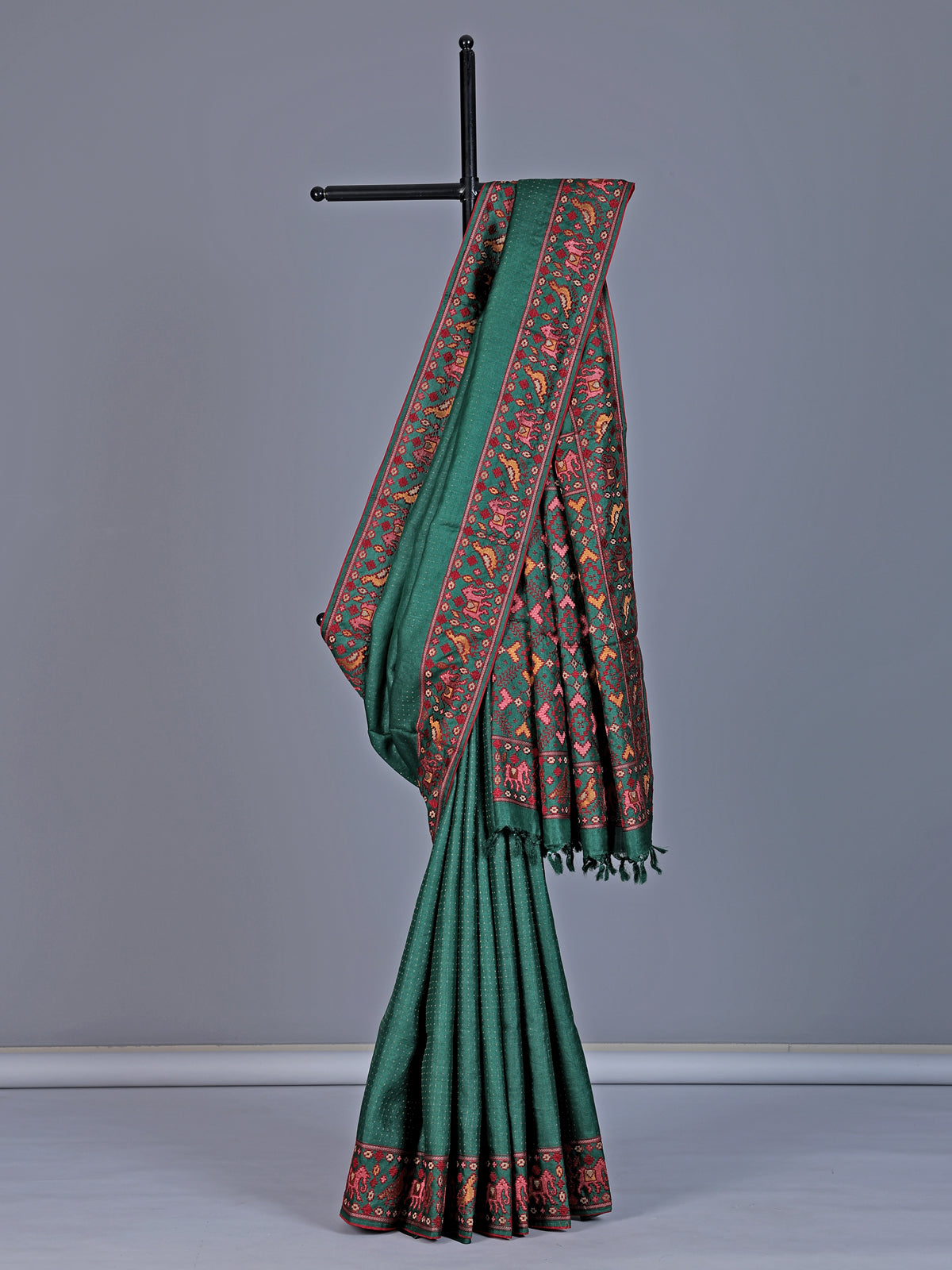 Deep green tusser silk saree with intricate animal motif artistry