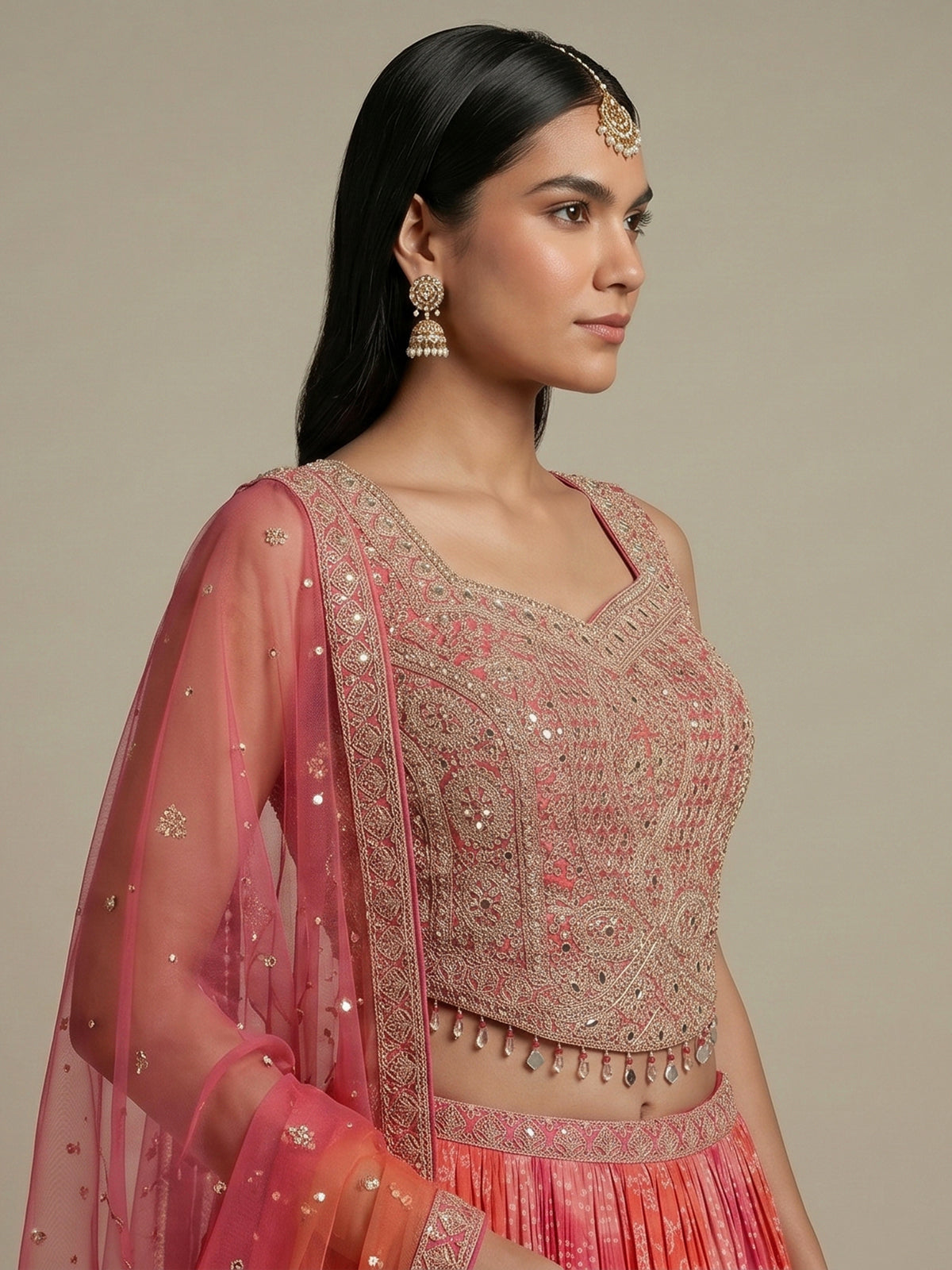 Pink silk bandhej lehenga choli with mirror and tassel work