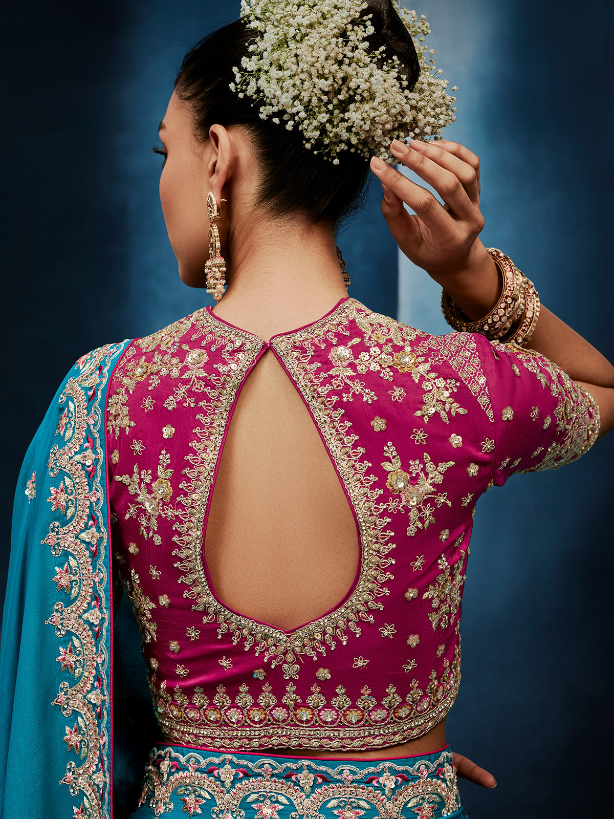 Blue silk saree paired with a striking red blouse