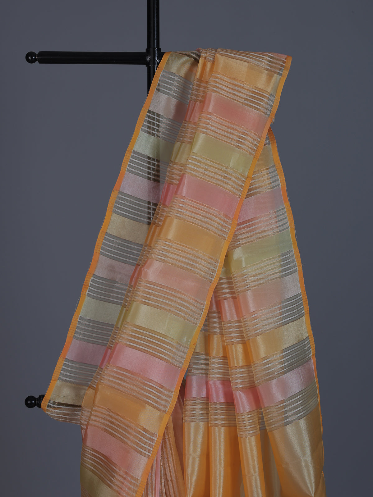 Peach striped organza saree for elegant sangeet evenings