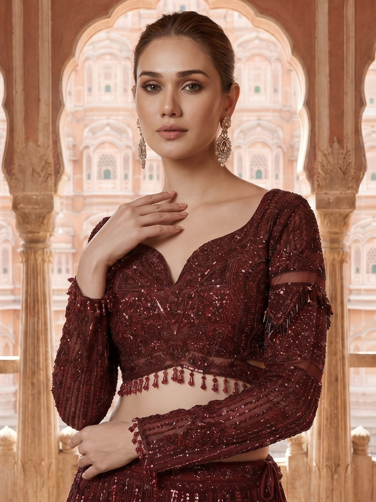 Maroon net lehenga choli with intricate handwork