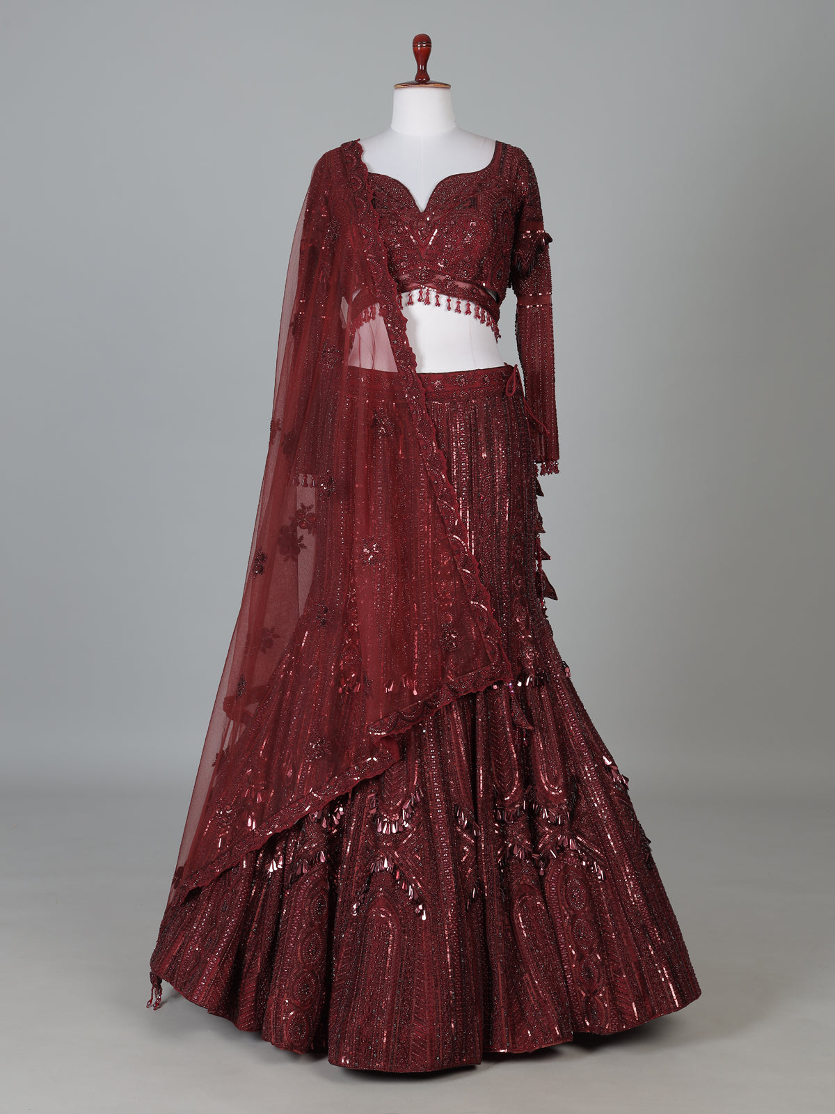 Maroon net lehenga choli with intricate handwork