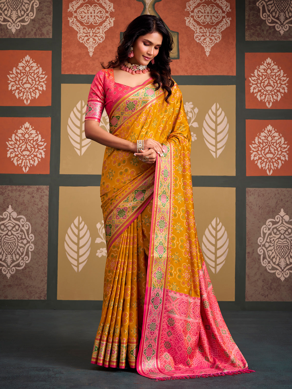 Radiant mustard yellow patola silk saree with contrast light pink blouse