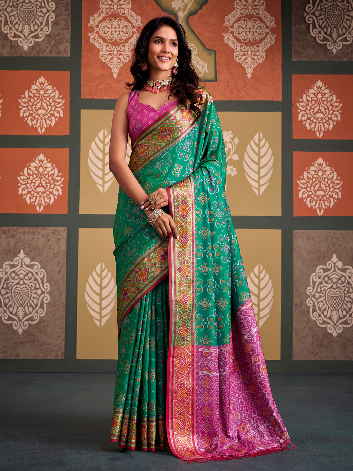 Regal green geometric patola silk saree with contrast pink blouse