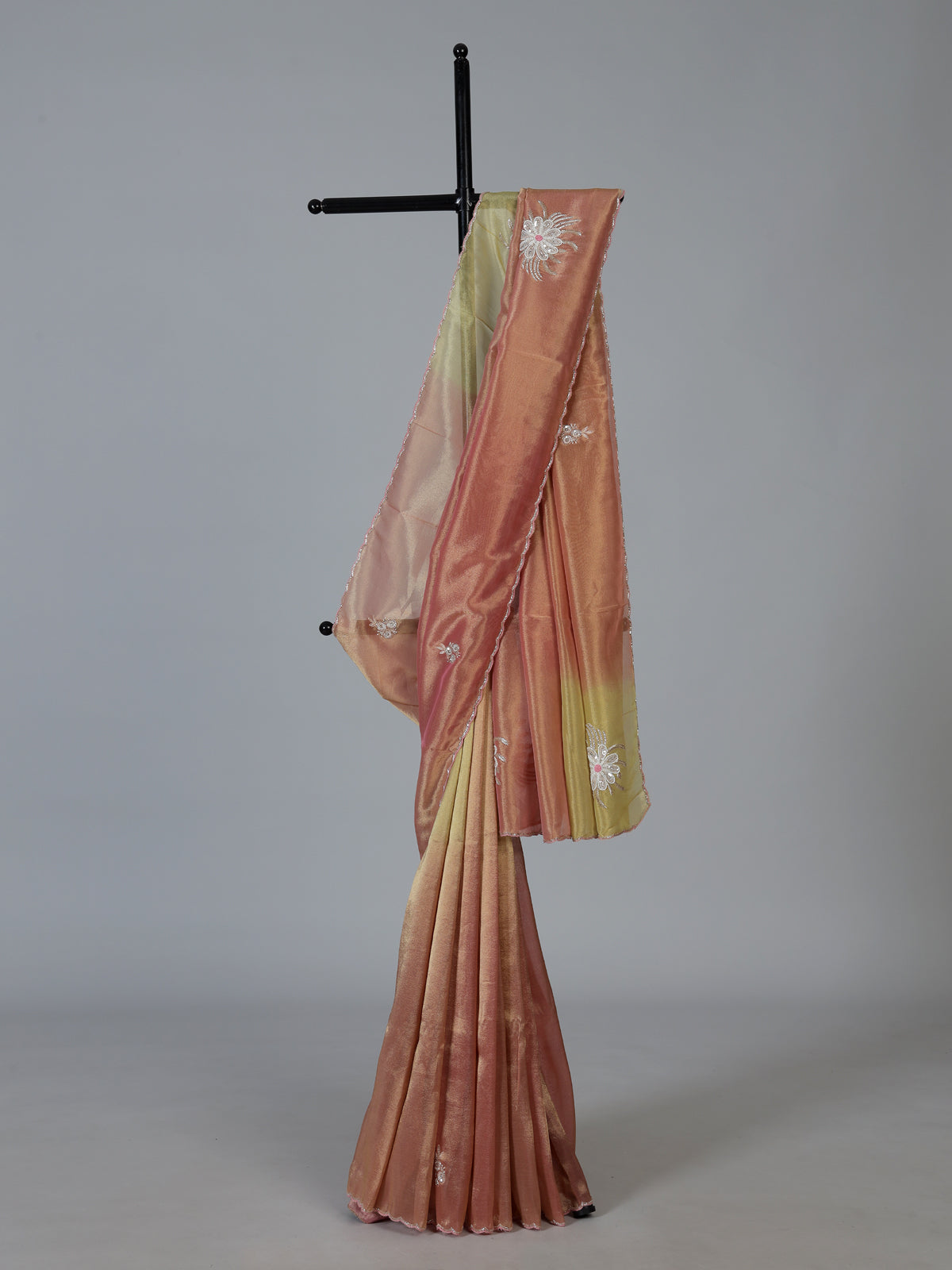 Peach shaded tissue silk designer saree with elegant festive shimmer