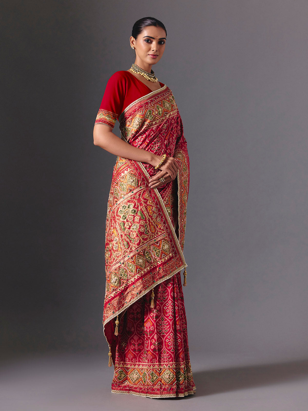 Rani pink art silk patola saree with festive handcrafted embellishments