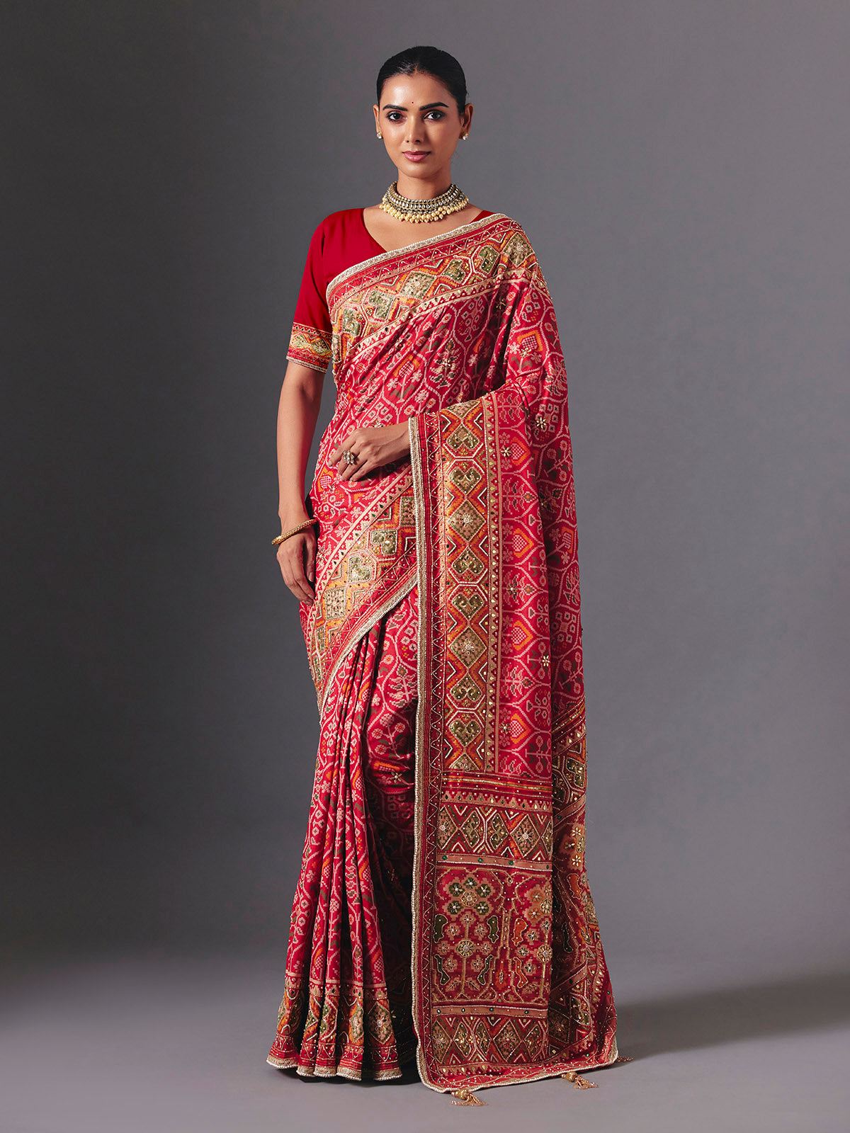 Rani pink art silk patola saree with festive handcrafted embellishments