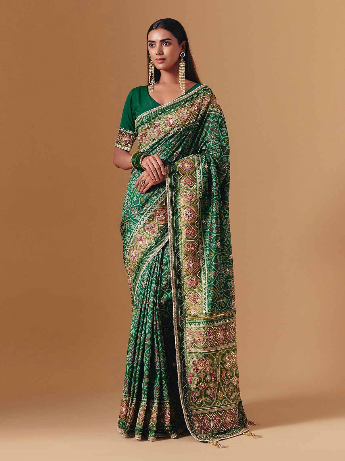 Green art silk patola print saree with timeless festive elegance