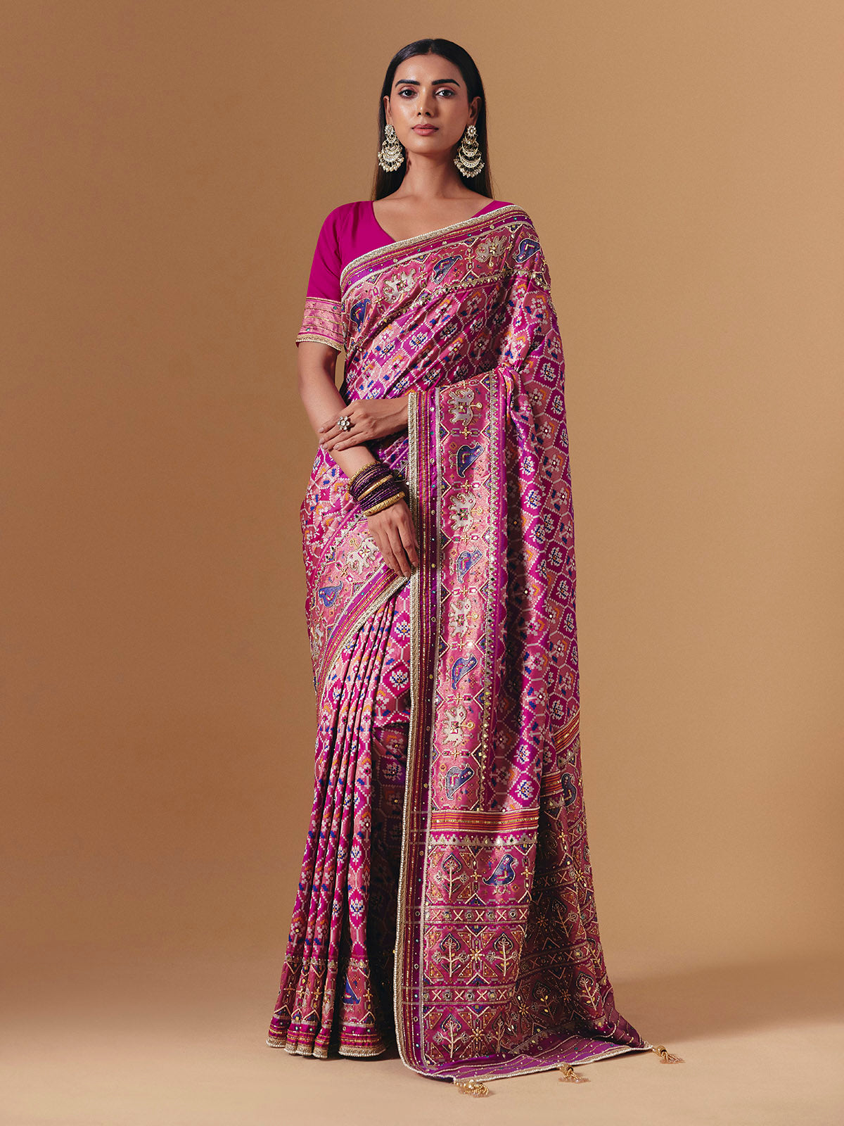 Rani pink art silk saree with graceful patola motif detailing