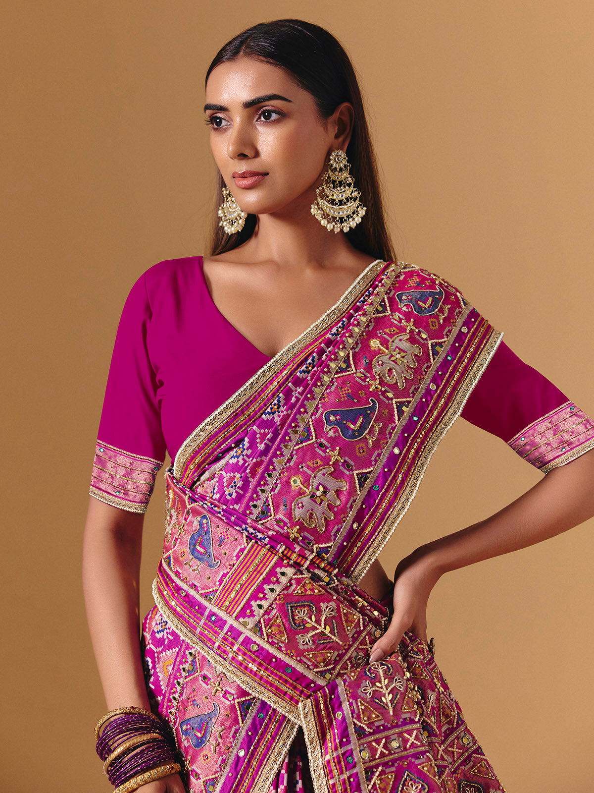 Rani pink art silk saree with graceful patola motif detailing