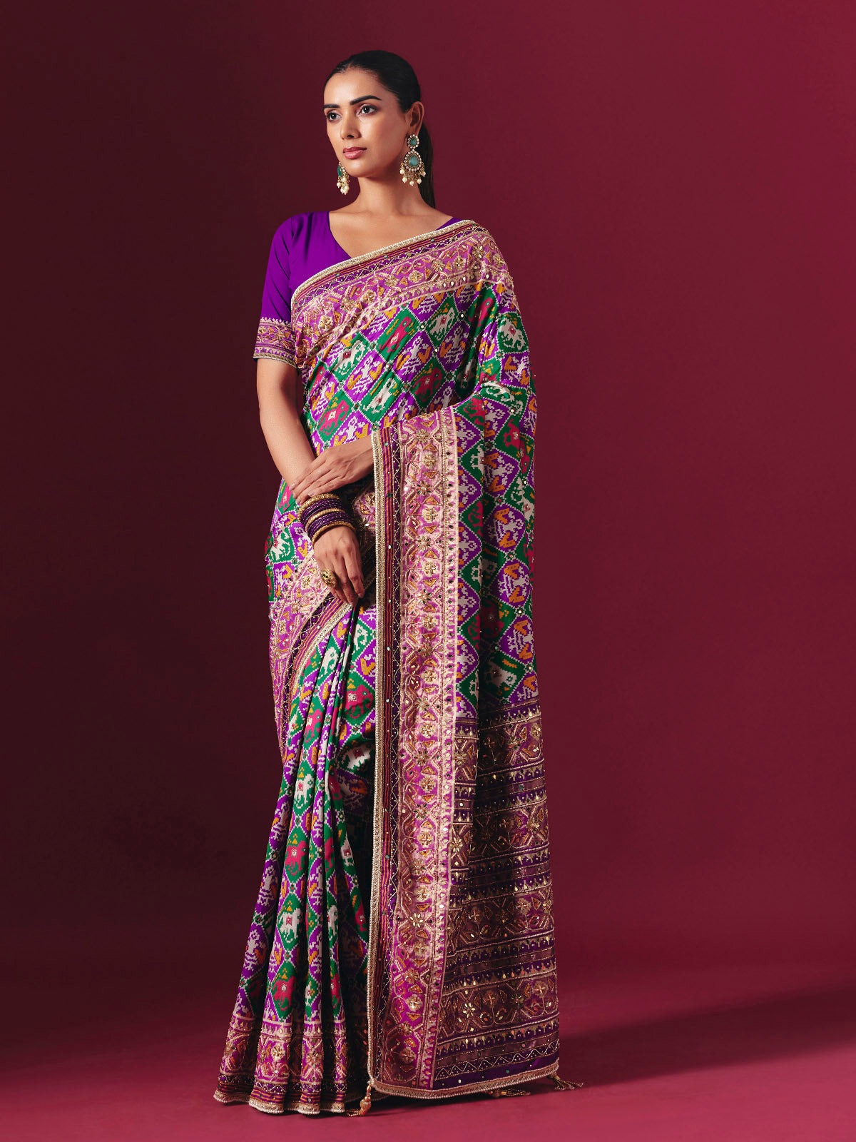 Purple and green art patola silk saree with festive motifs