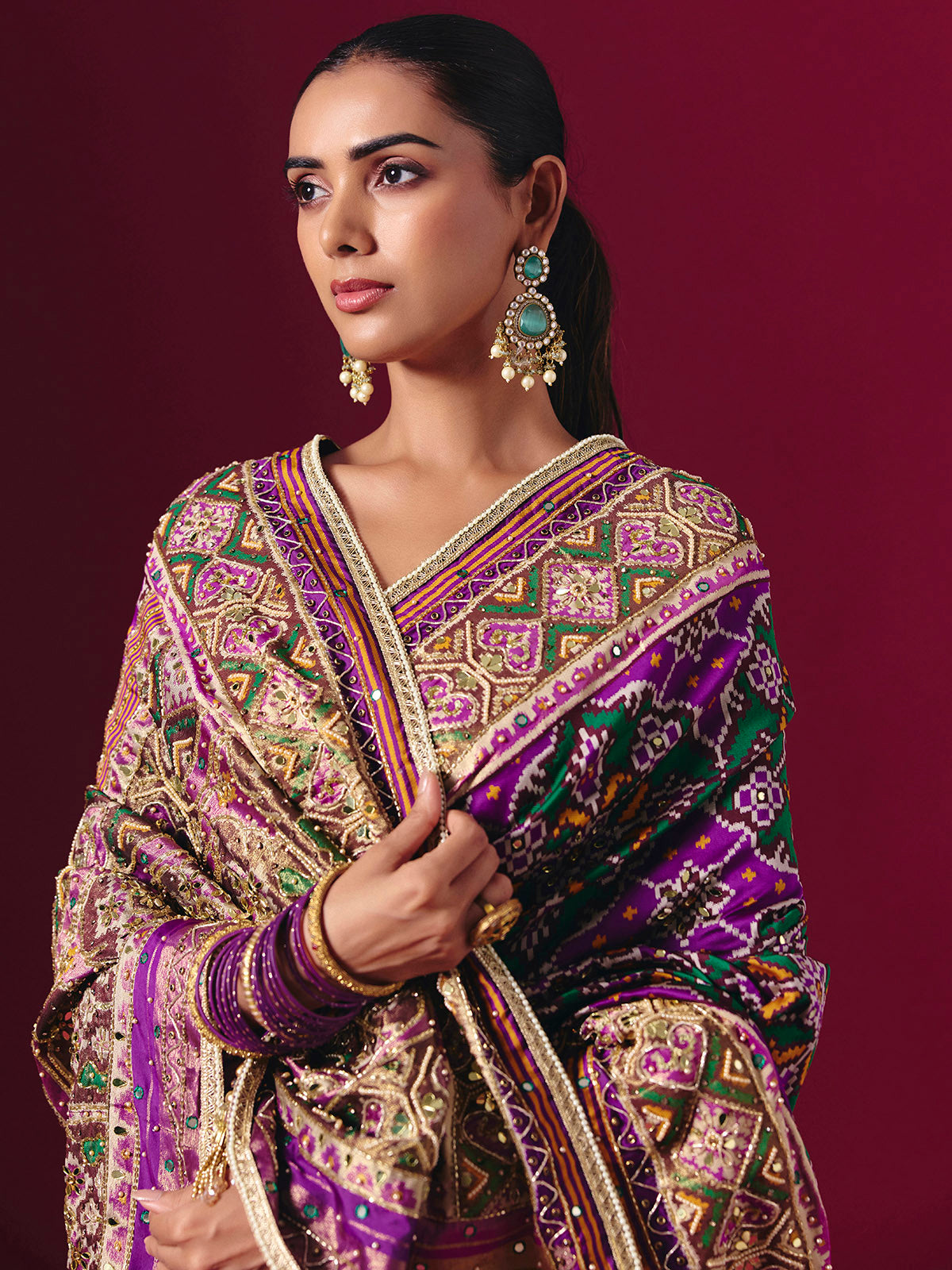 Purple and green art patola silk saree with festive motifs