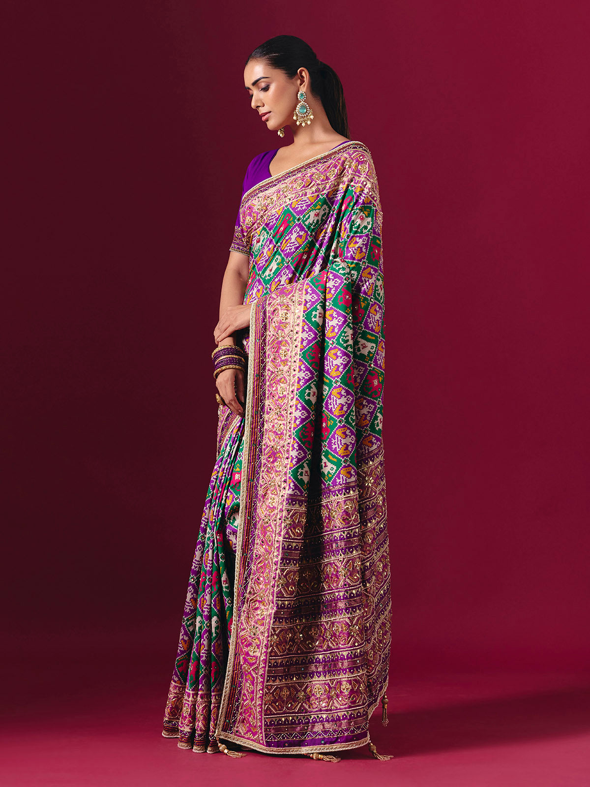 Purple and green art patola silk saree with festive motifs