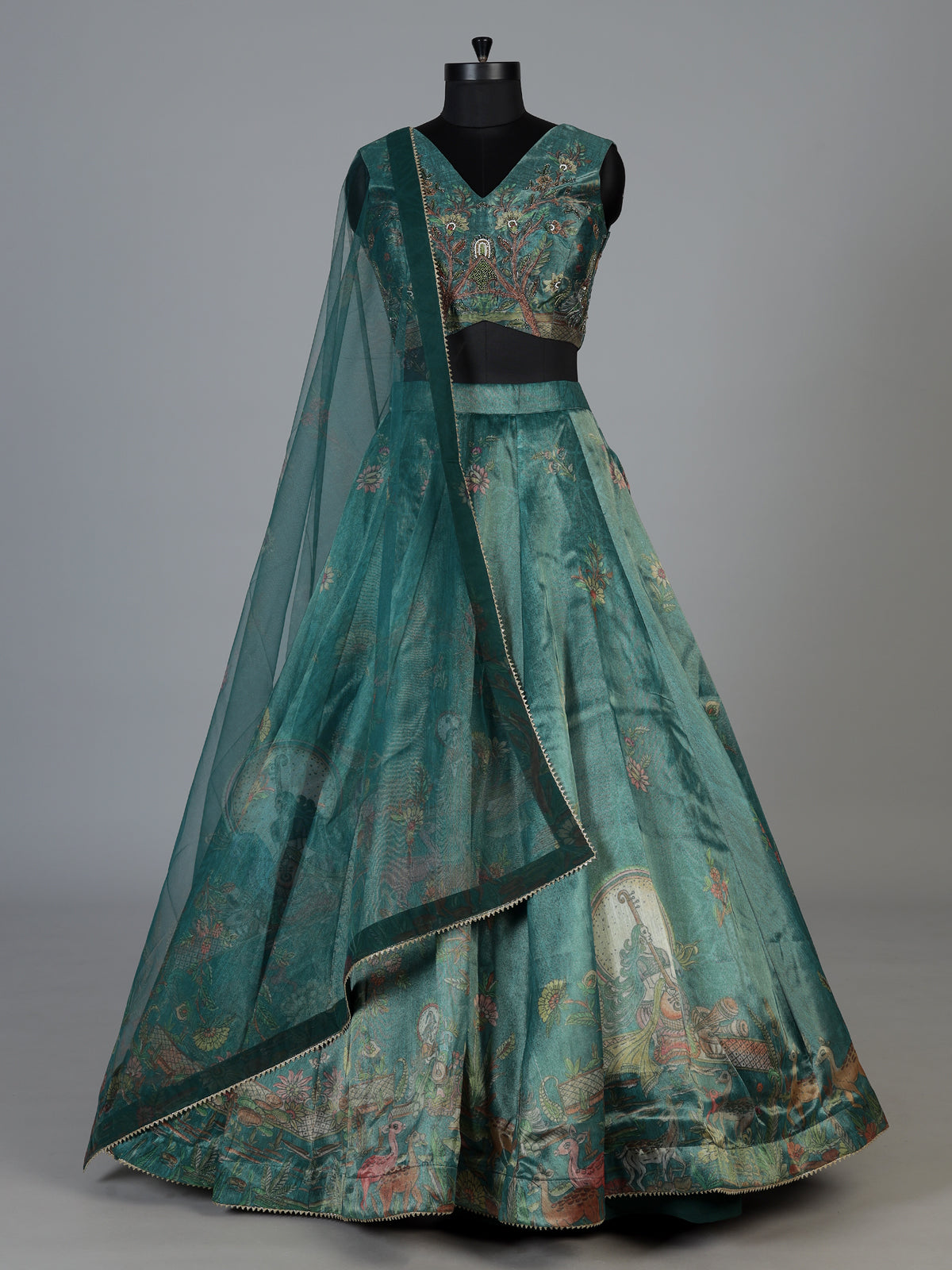 Teal green pichwai printed crepe silk lehenga choli ensemble