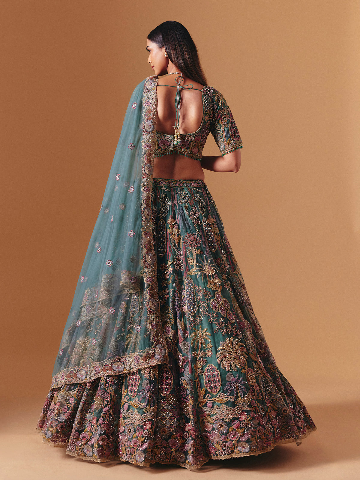 Teal green net designer lehenga choli with elegant dupatta grace