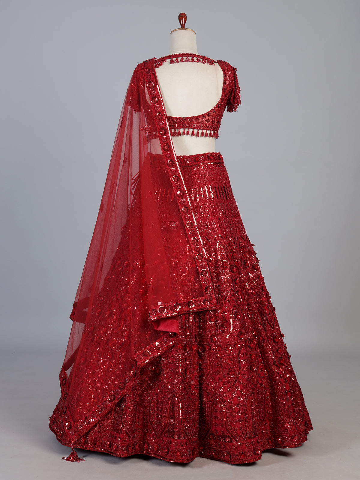 Maroon net designer lehenga choli with stone work tassel detailing