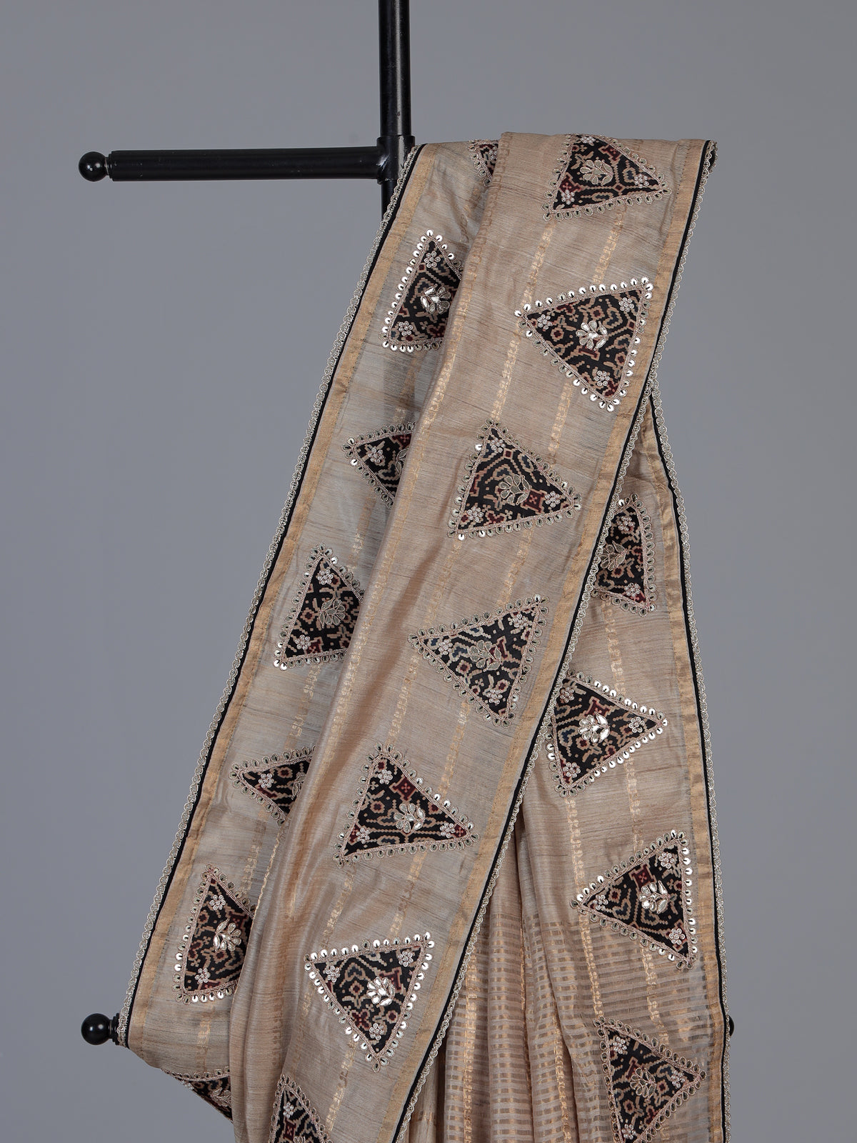 Pastel beige tusser silk saree with traditional handcrafted embellishments
