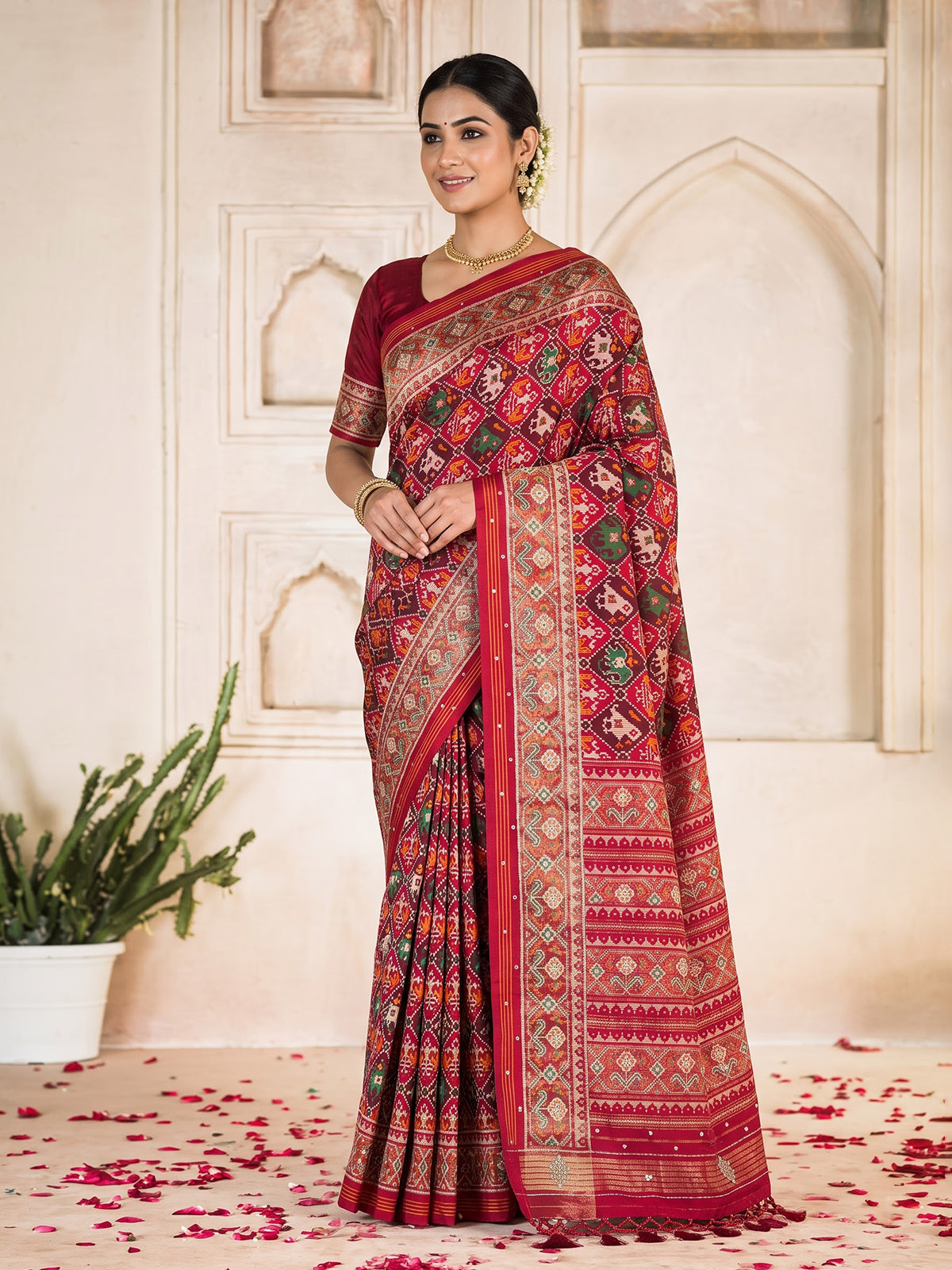 Red art patola silk saree with elegant stone work