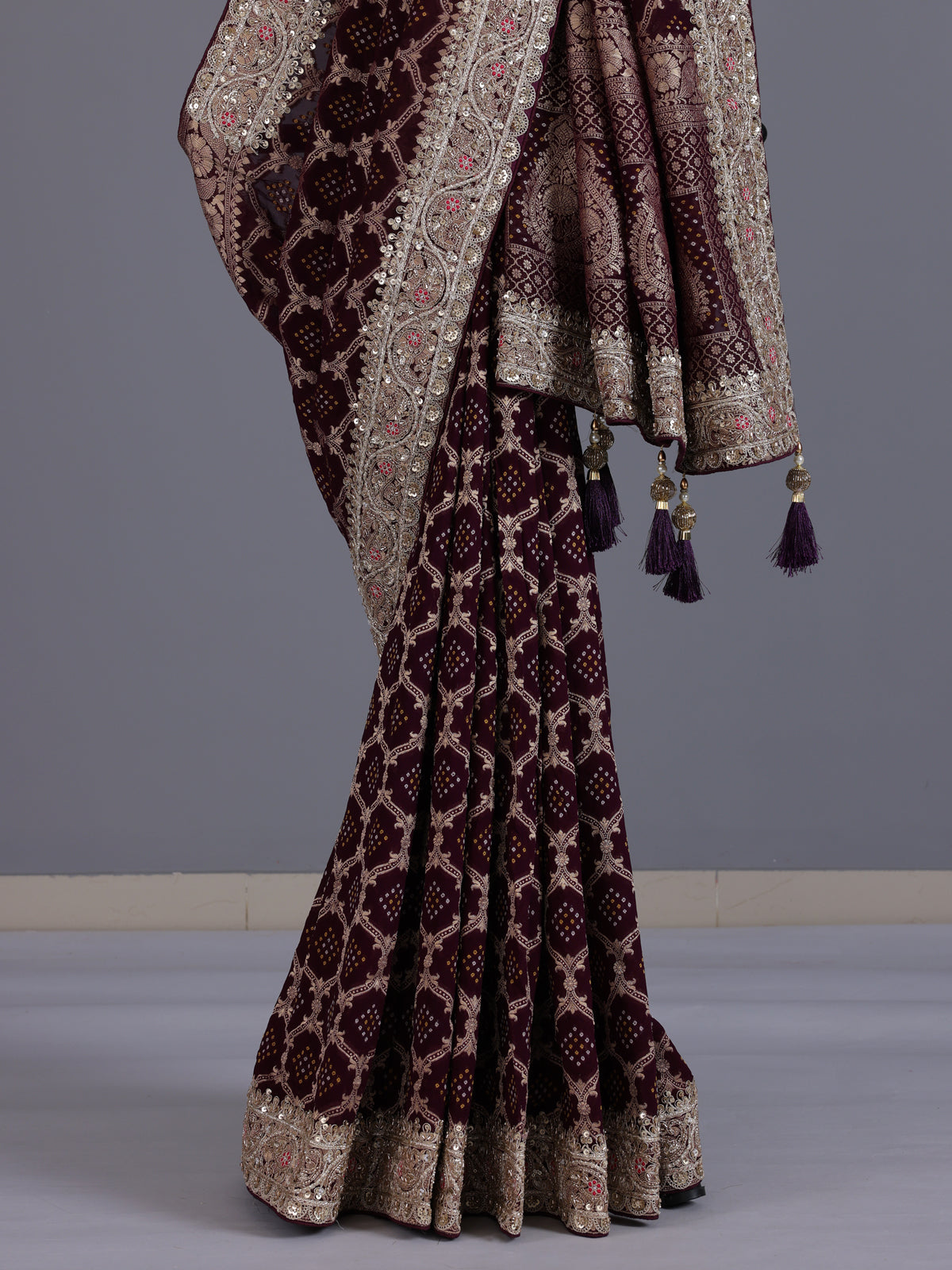 Wine bandhani semi georgette saree with elegant tassel pallu detailing