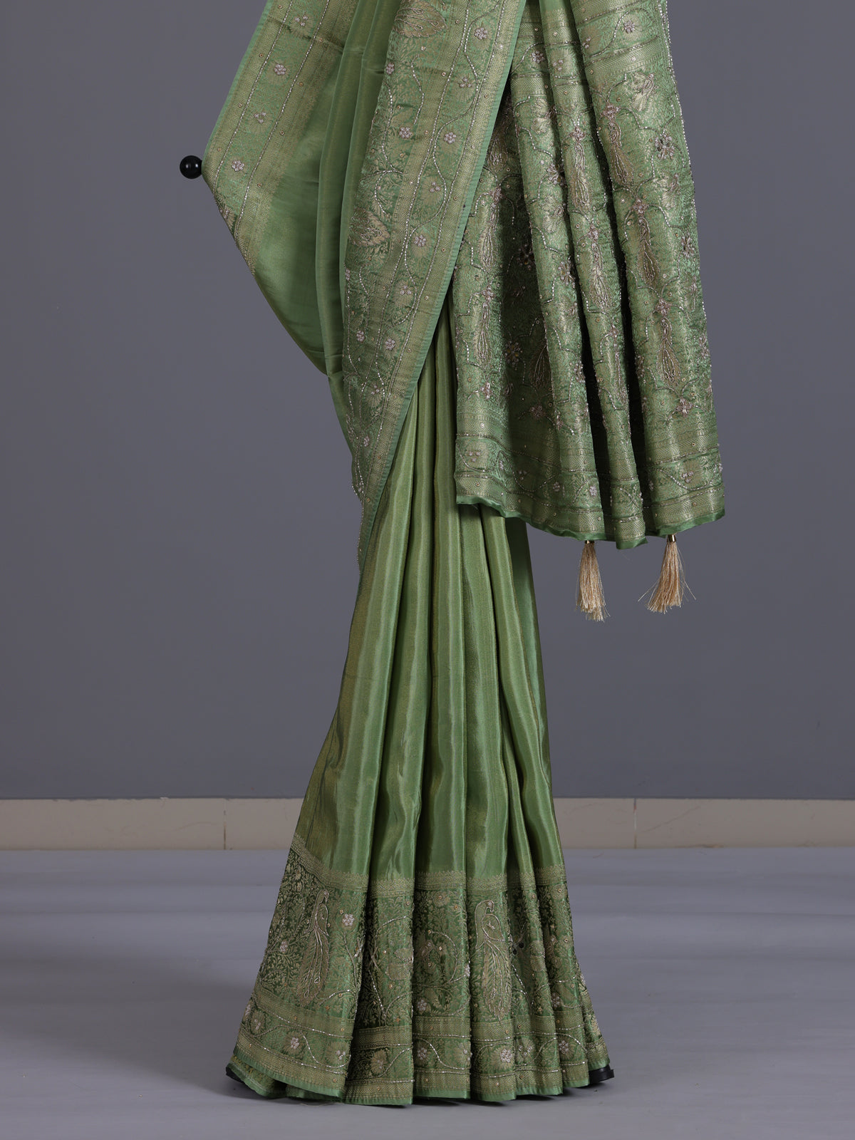Pastel pista green shimmer dola silk saree with peacock motifs
