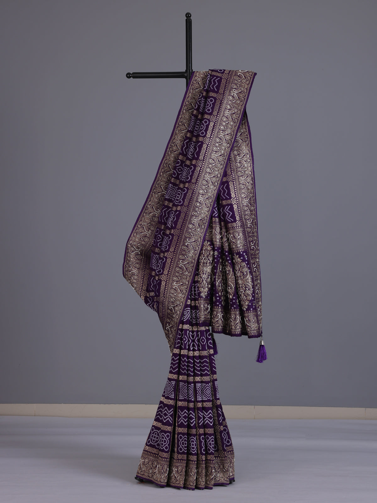 Purple dola silk bandhani saree with luxurious tassel pallu detailing