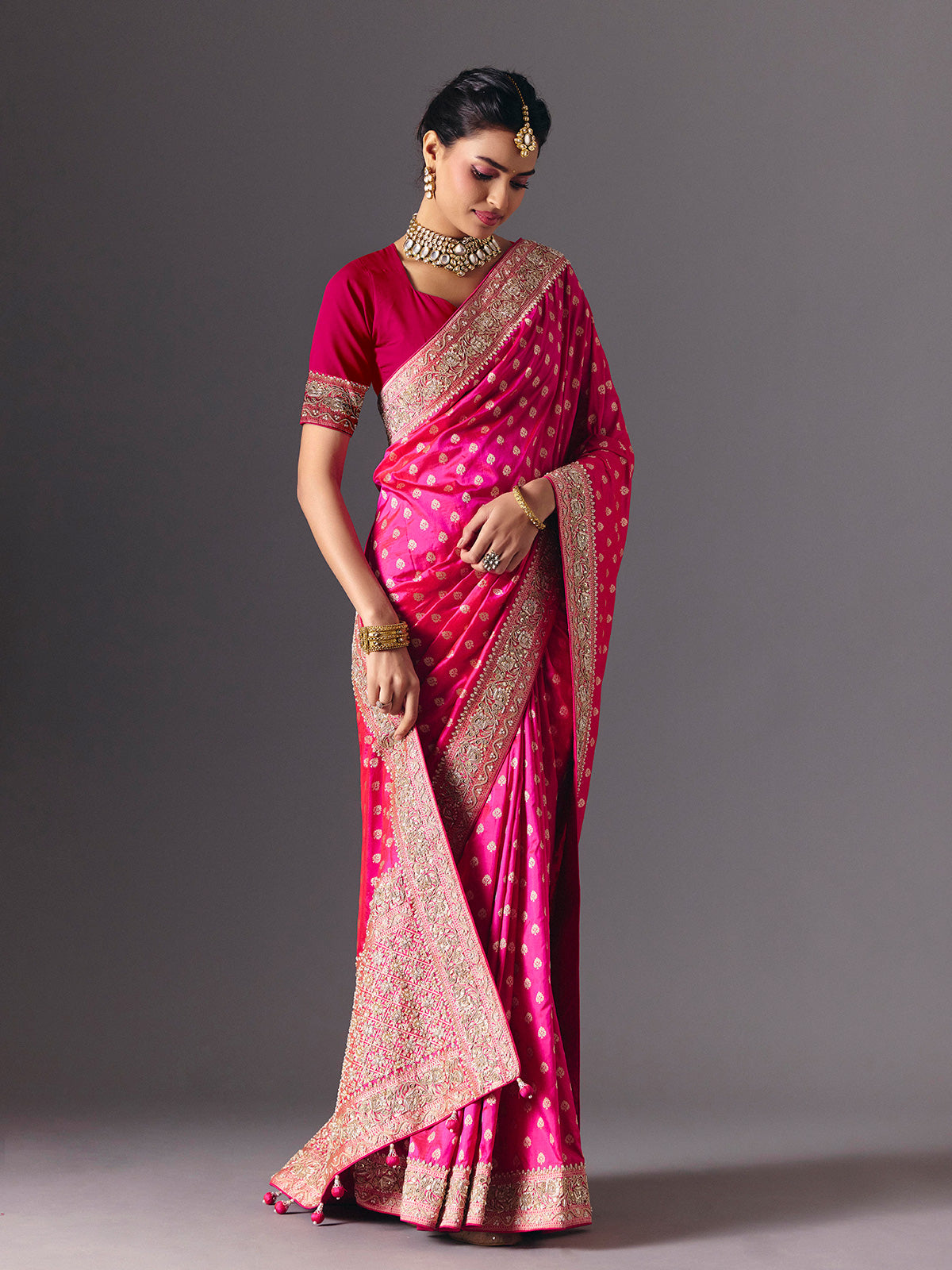 Rani pink banarasi silk saree with butti work and tassels