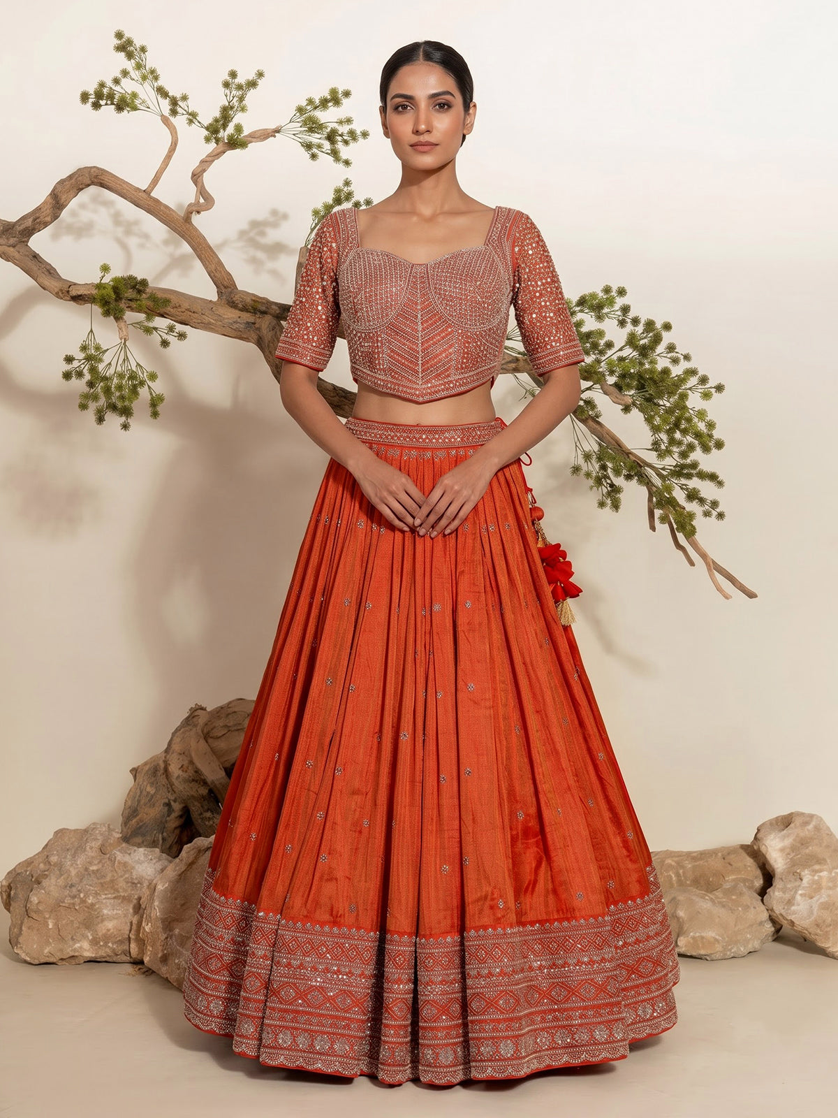 Rust orange silk embellished designer lehenga choli with tassel dupatta