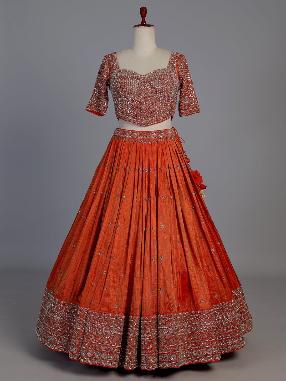 Rust orange silk embellished designer lehenga choli with tassel dupatta