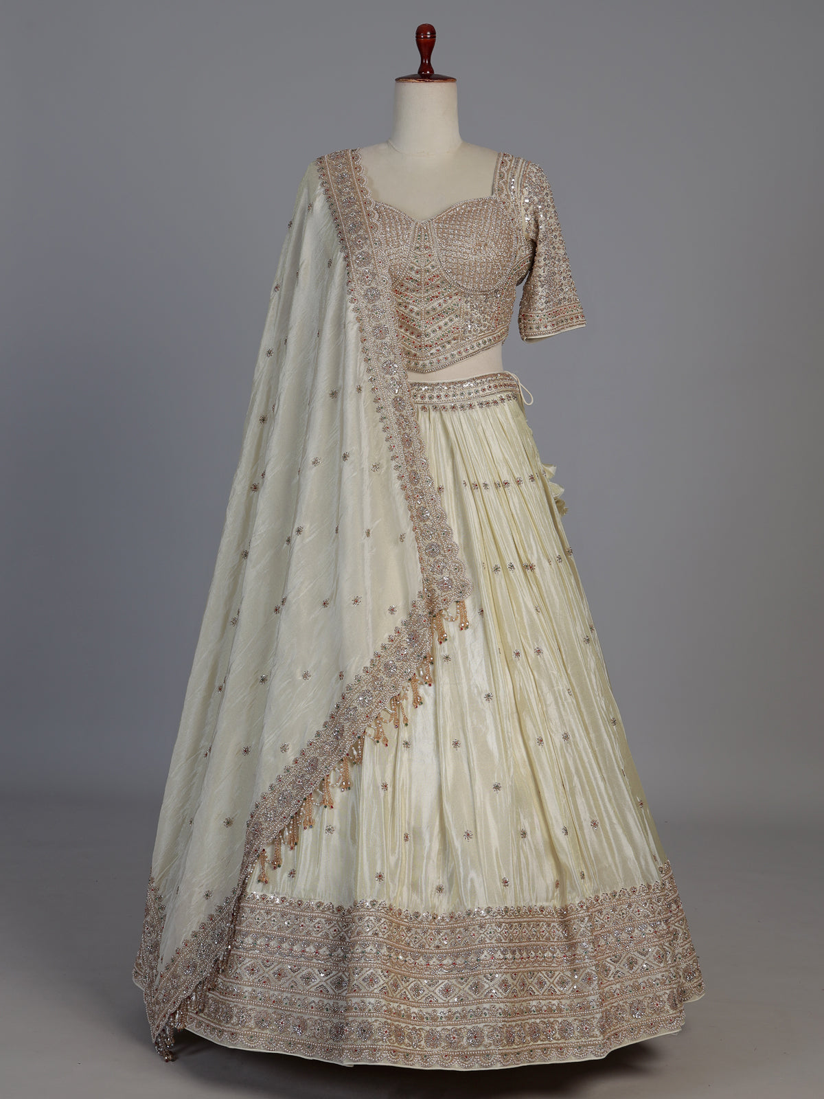Cream silk designer embellished lehenga choli with tassel dupatta