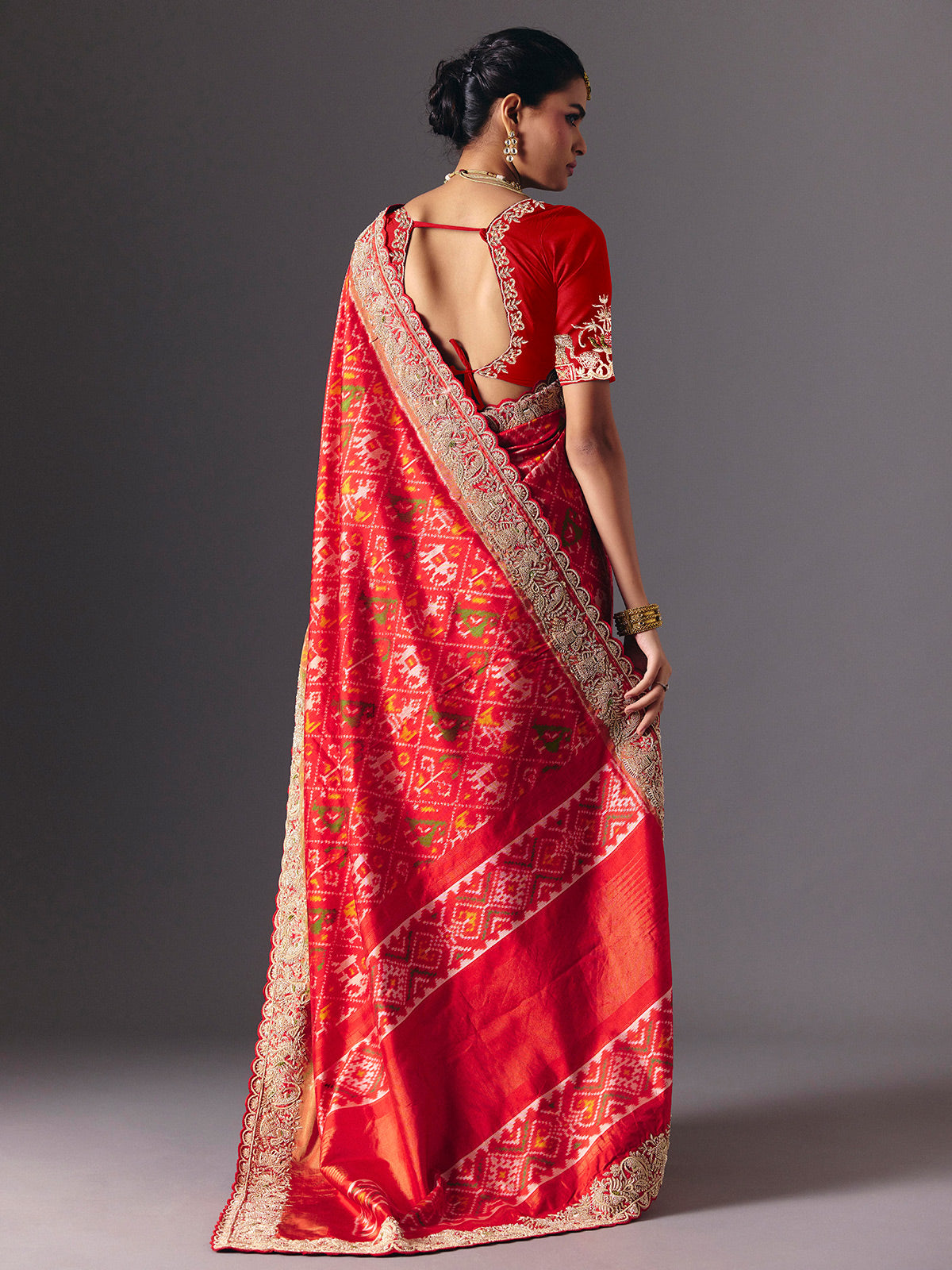 Red Hyderabadi patola silk saree with luxurious printed bridal artistry