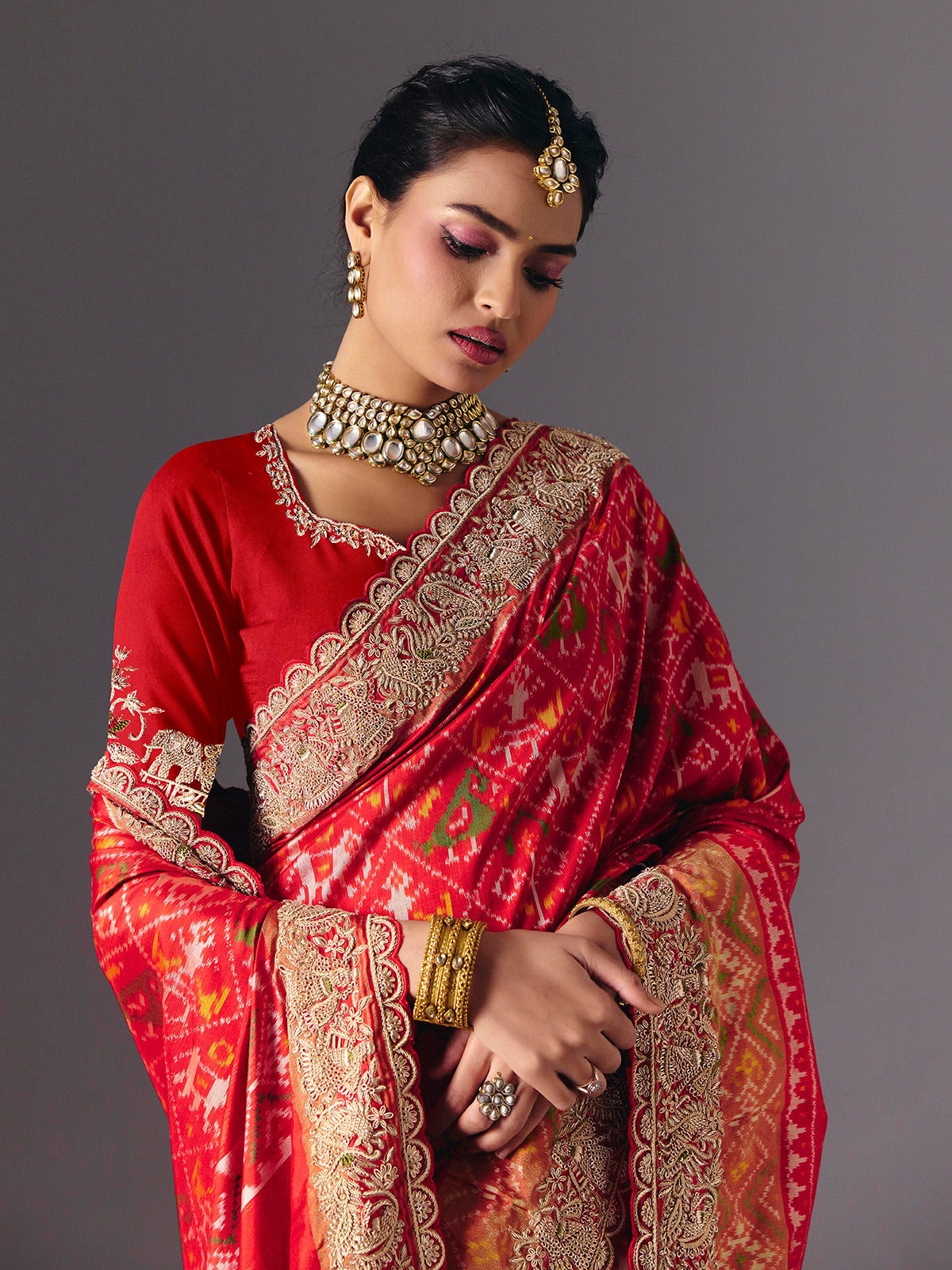 Red Hyderabadi patola silk saree with luxurious printed bridal artistry