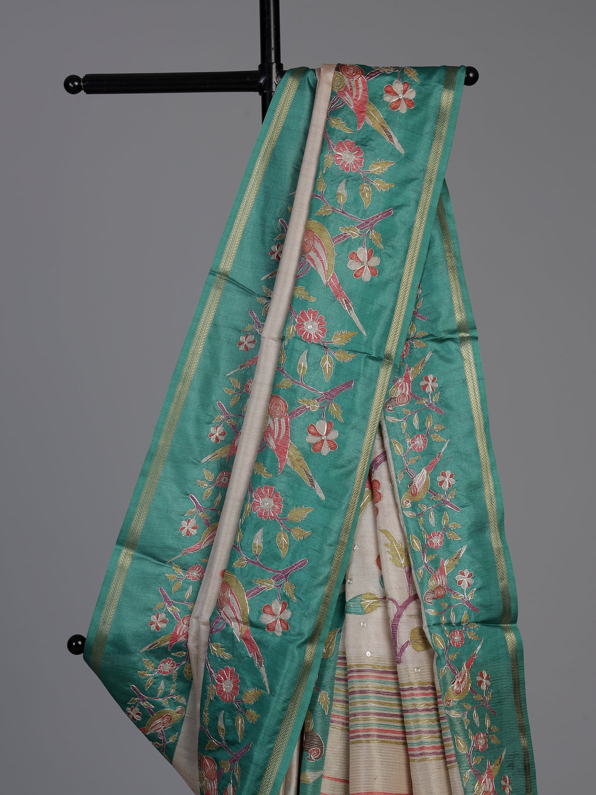 Beige and green art tusser silk saree with elegant bird motifs