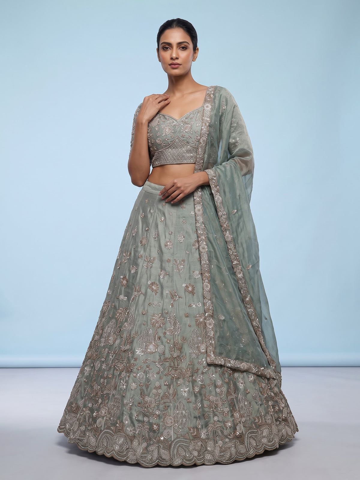 Pista green silk lehenga choli with elephant bird motifs